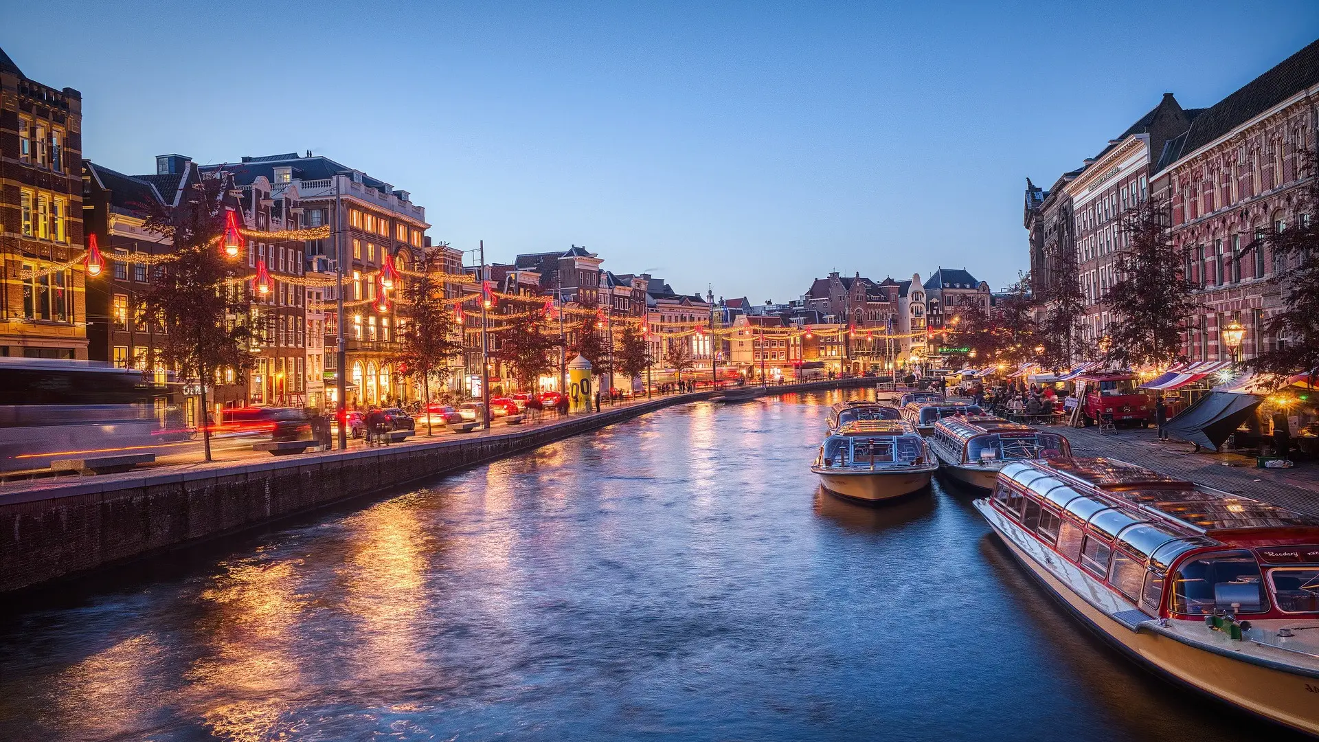 Large lake and beautiful houses, boats and christmas lightning in Amsterdam, The Netherlands.