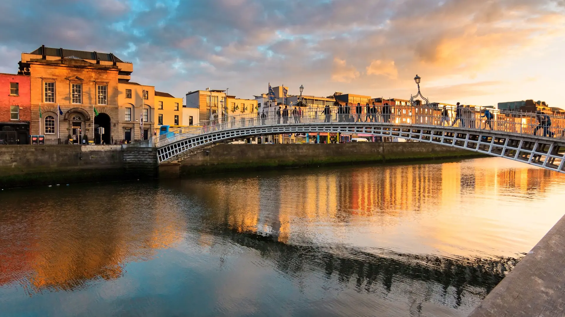 Bridge over lake in Dublin, with old school buildings.