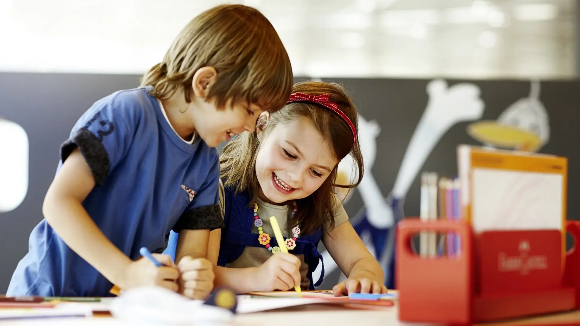 two kids drawing and having fun at a business class lounge 